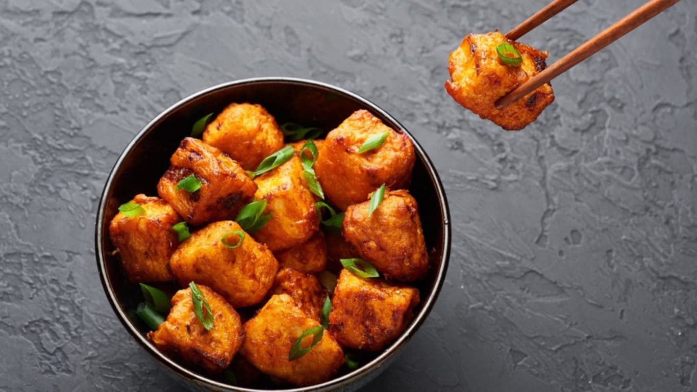 Spicy fried tofu bites in black bowl