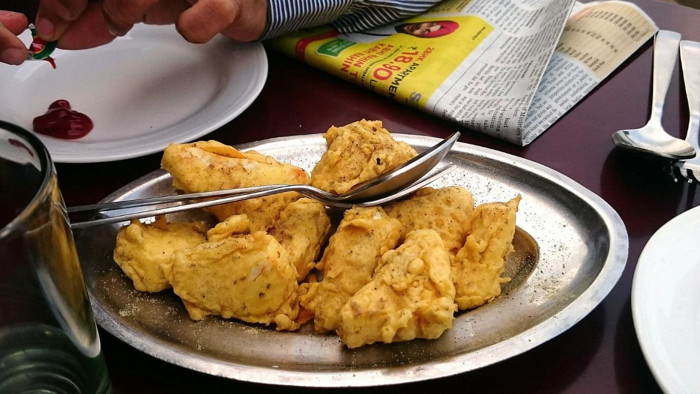 Plate of fried snacks with utensils