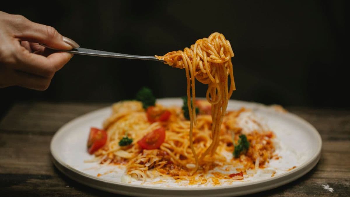 Pasta twirled in a fork on plate