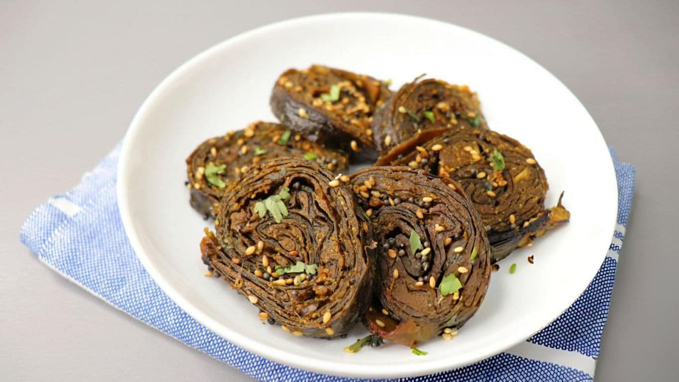 Spiced colocasia rolls on white plate