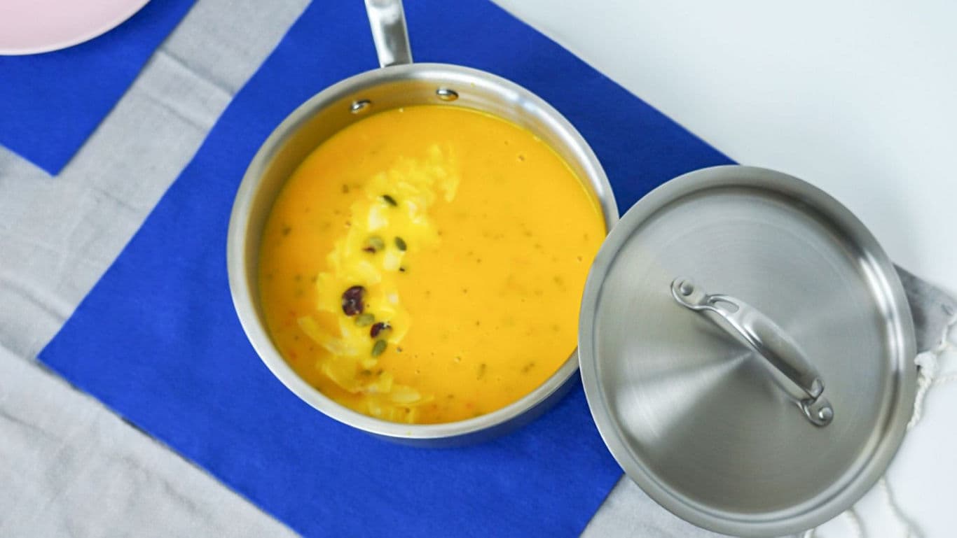 Stainless steel saucepan with creamy soup