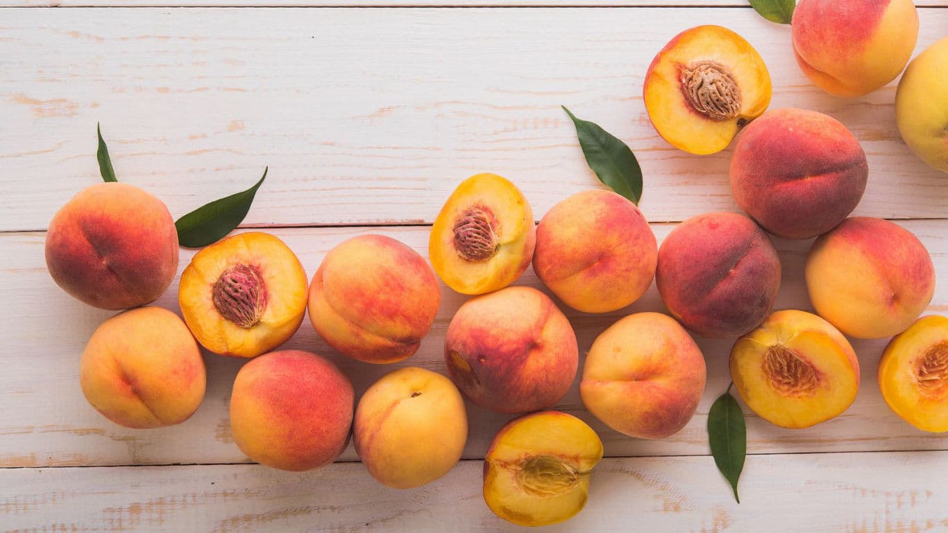 Fresh ripe peaches on rustic wooden table