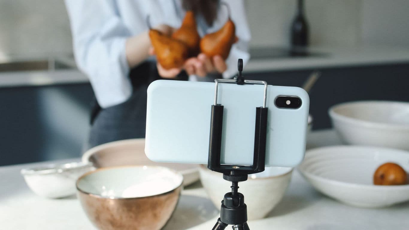 Person recording food video.