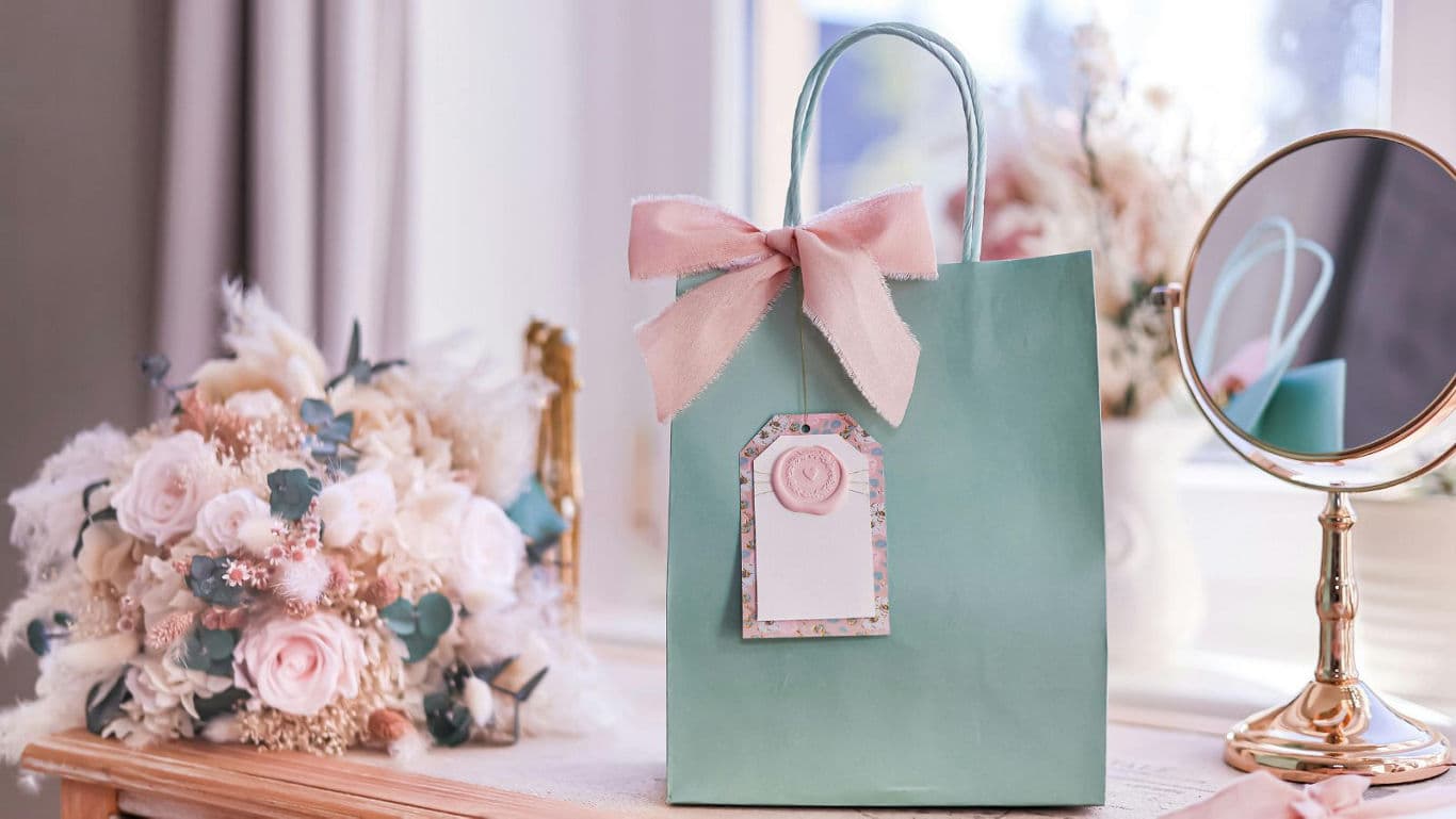 Elegant pastel gift bag with pink bow and tag