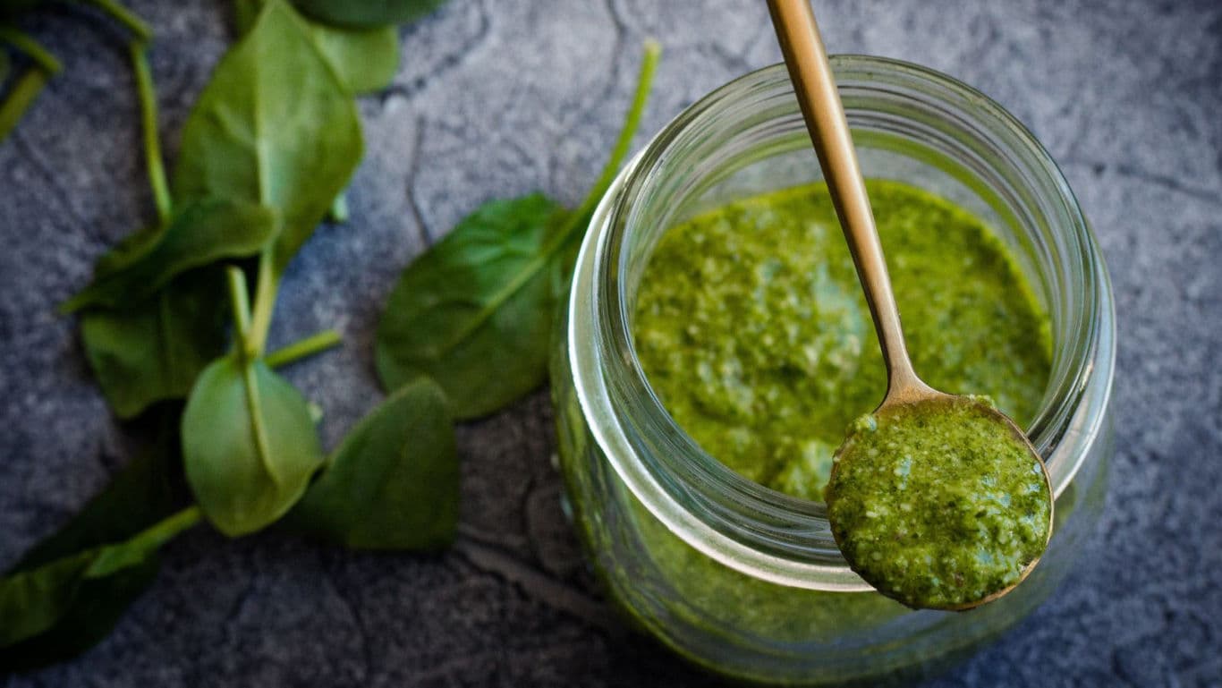 Fresh Green Pesto in Glass Jar with Spoon