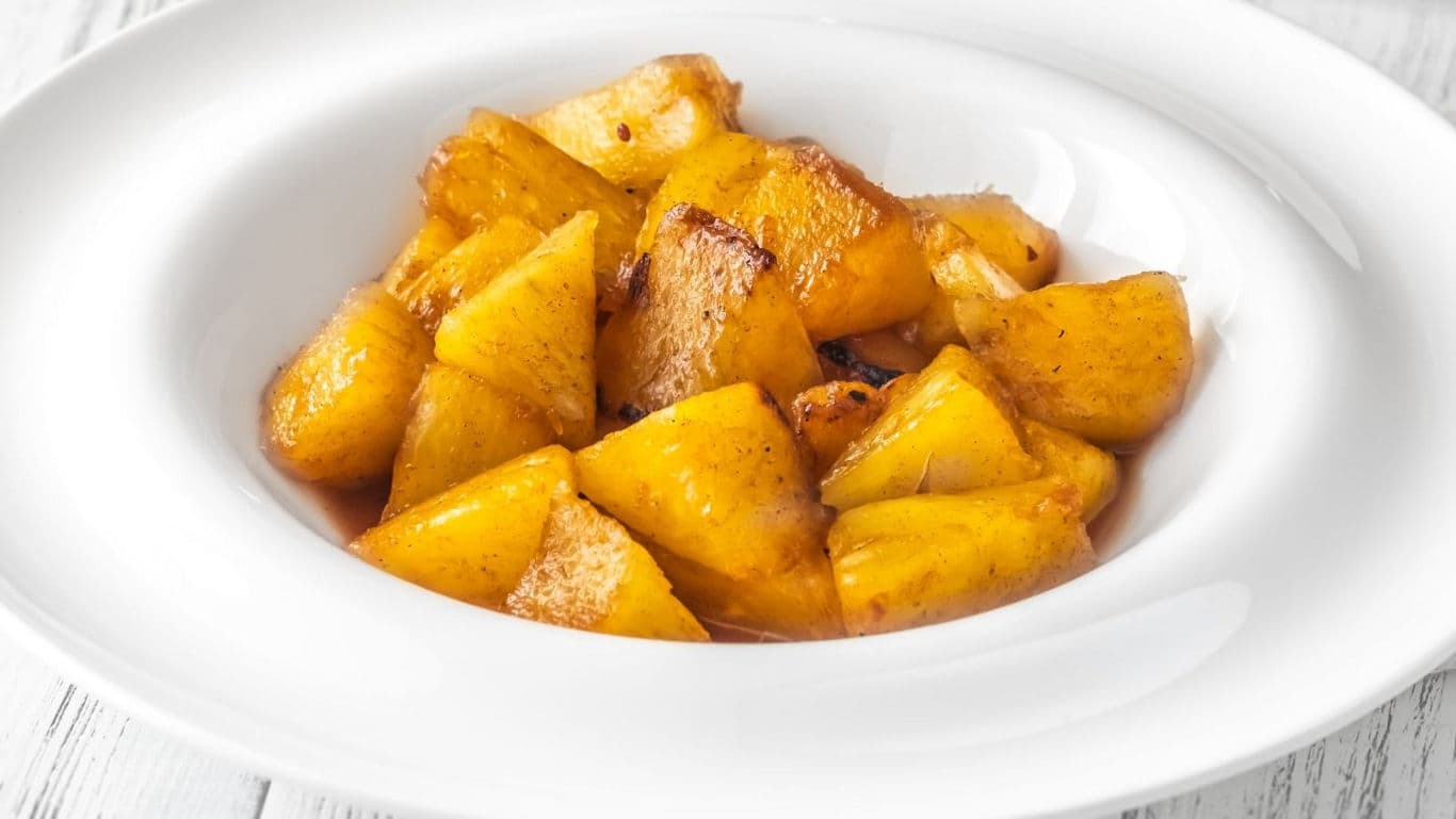 Bowl of caramelized roasted pineapple chunks