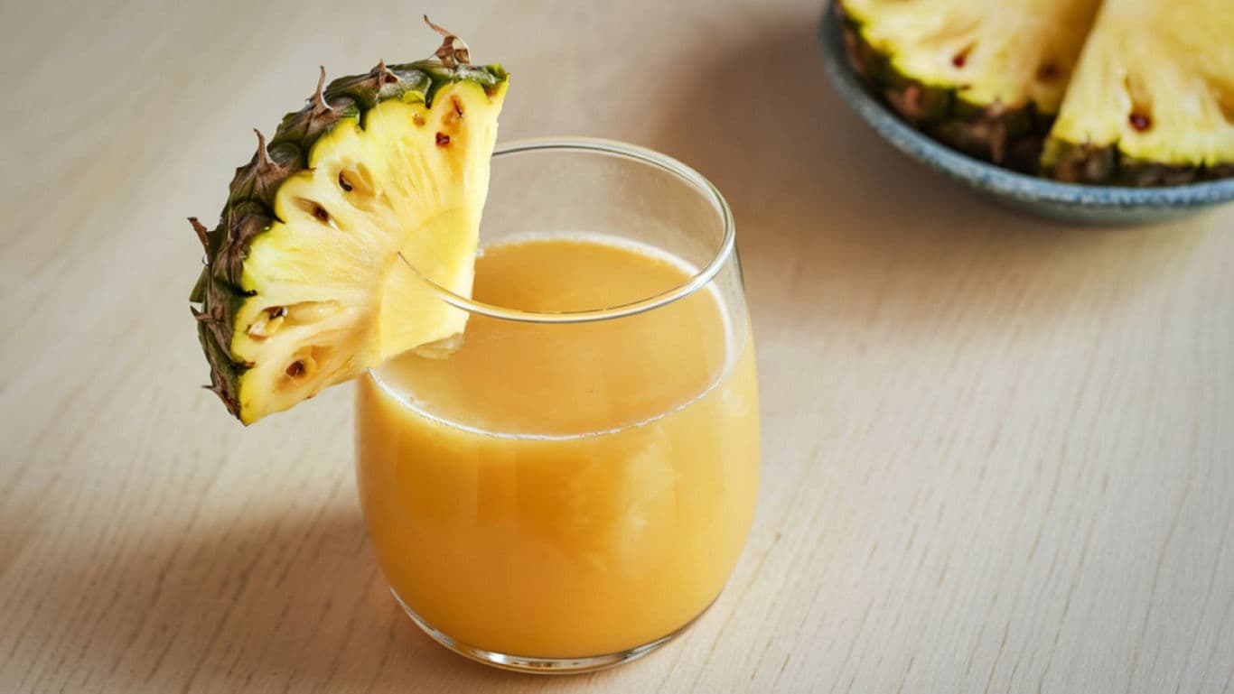 Fresh Pineapple Juice in Glass with Slice Garnish