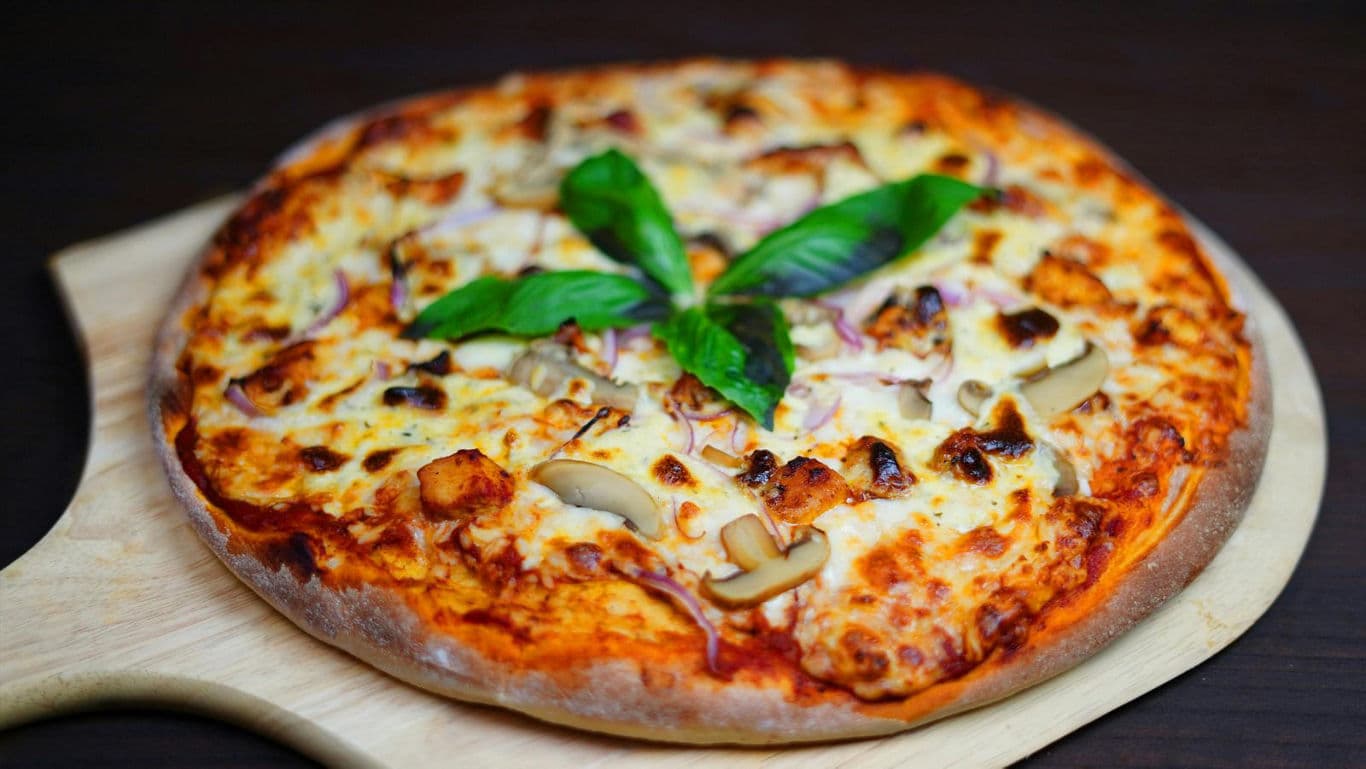 Freshly baked pizza with basil garnish