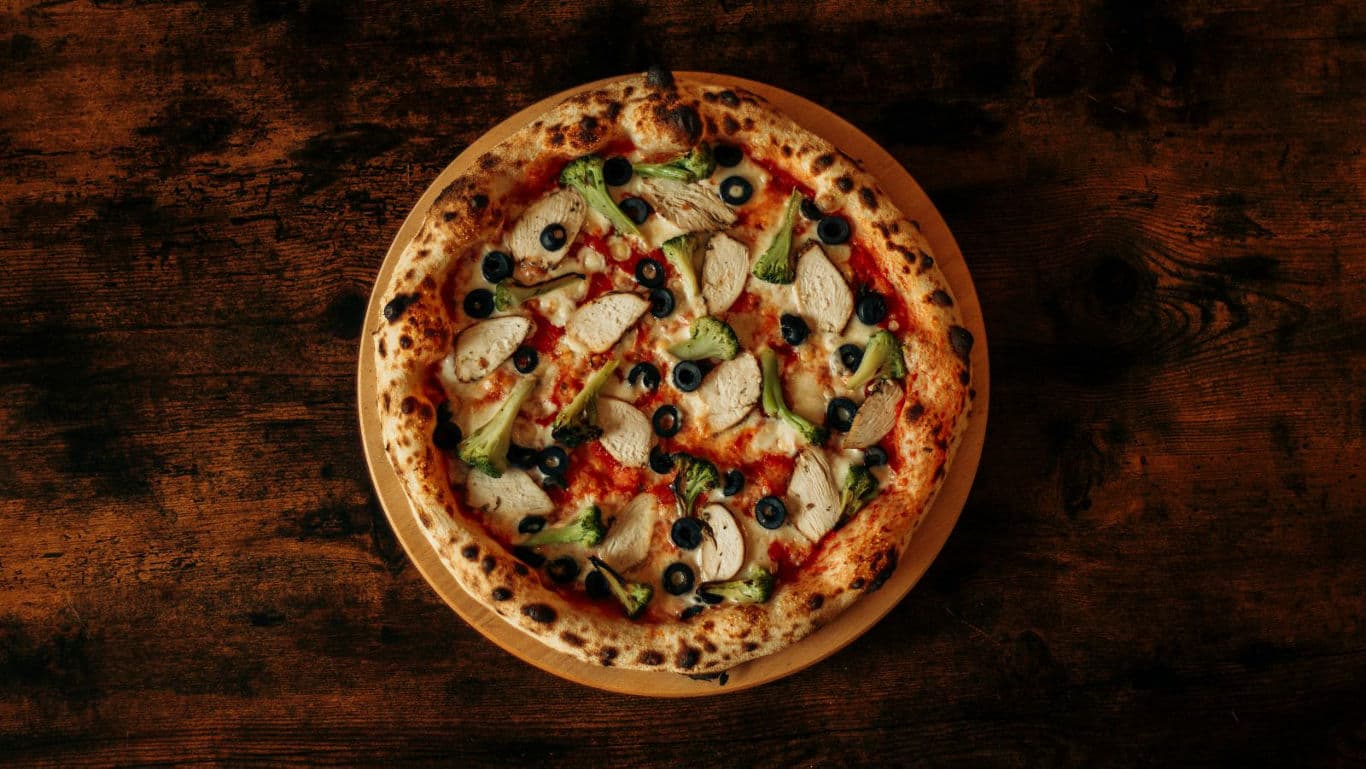 Wood-fired pizza with vegetables and olives