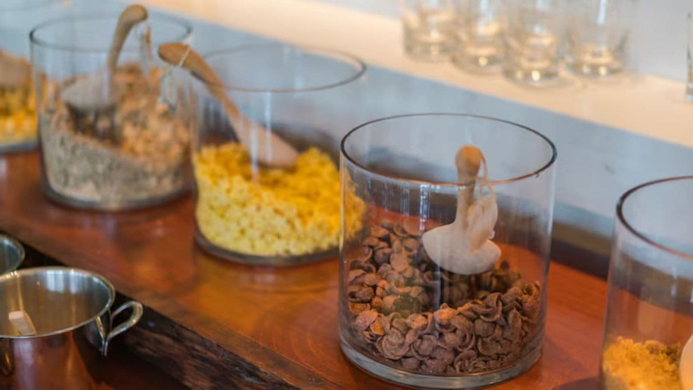 Assorted Breakfast Cereals in Glass Jars on Counter