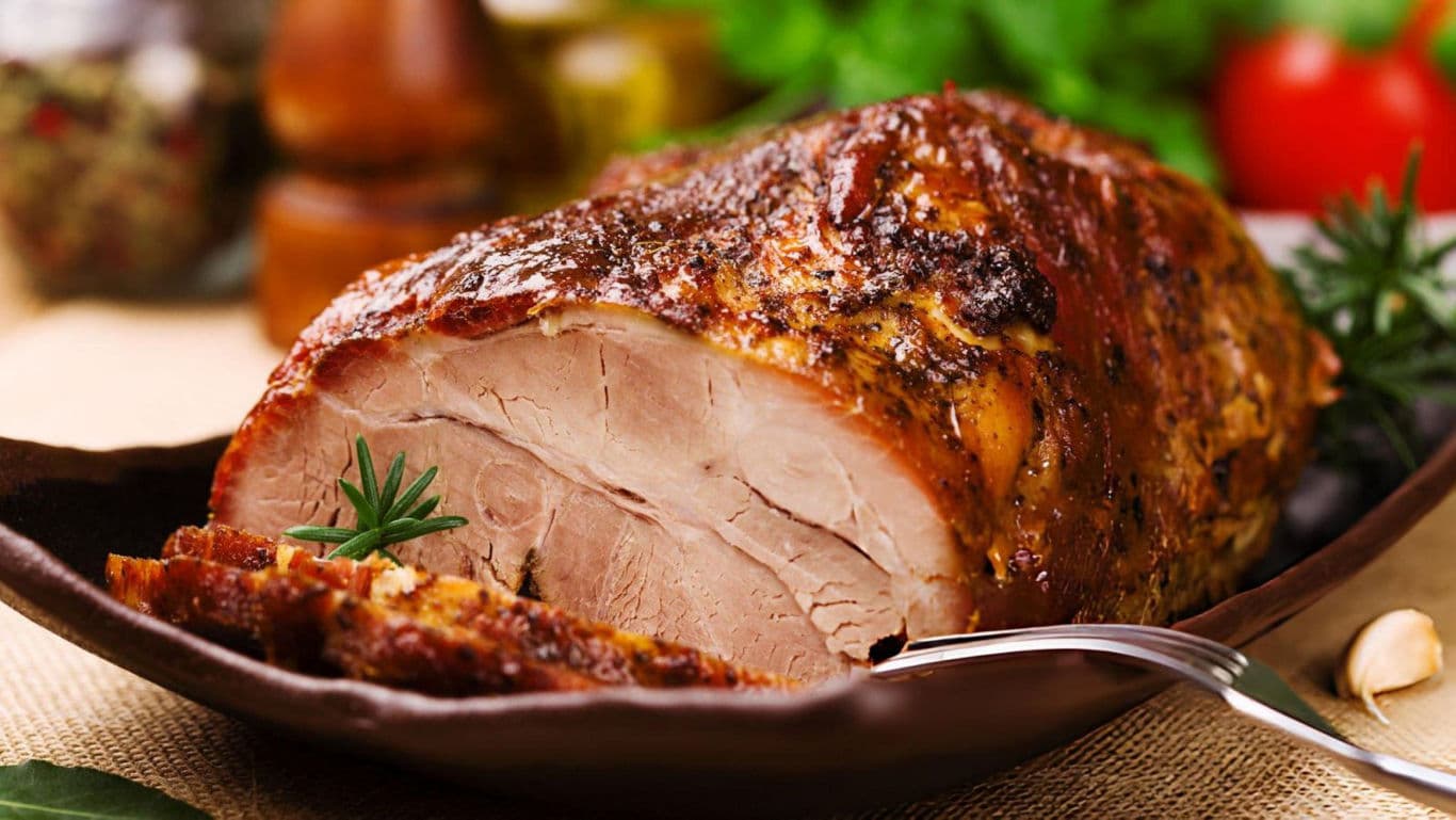 Roasted meat with herbs on platter