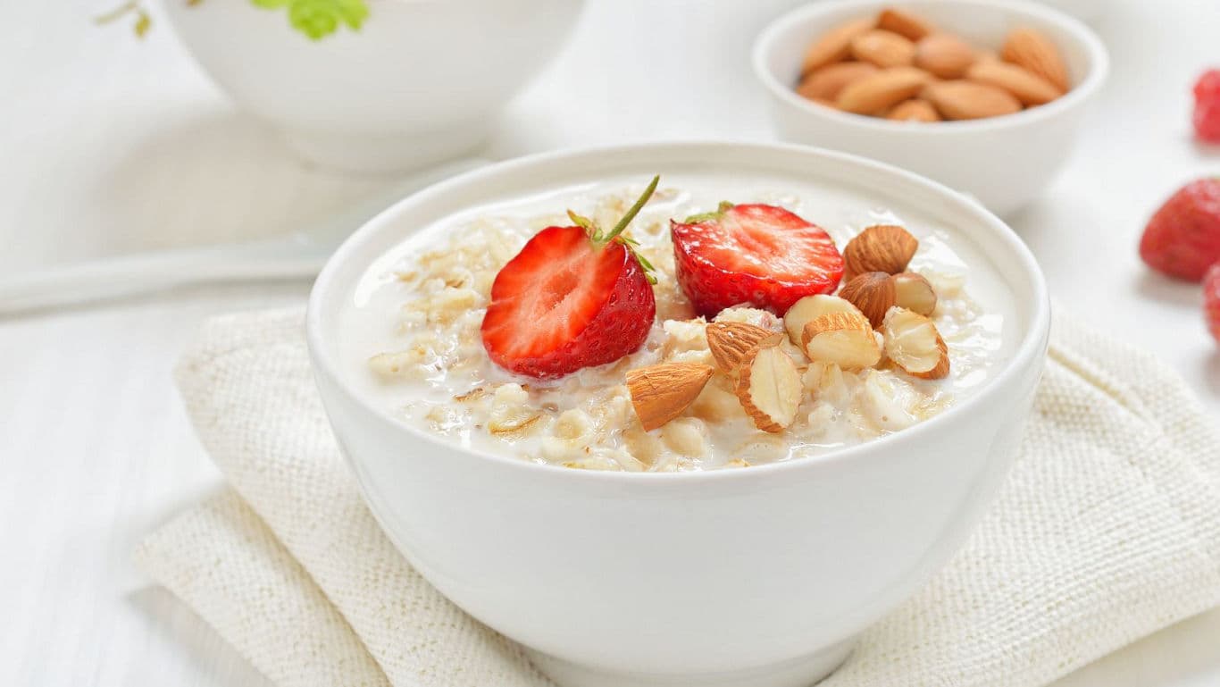 Bowl of oatmeal with strawberries and almonds