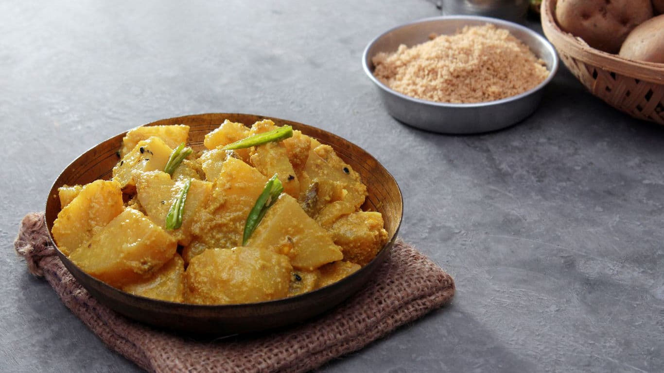 Spiced potato curry served in rustic bowl