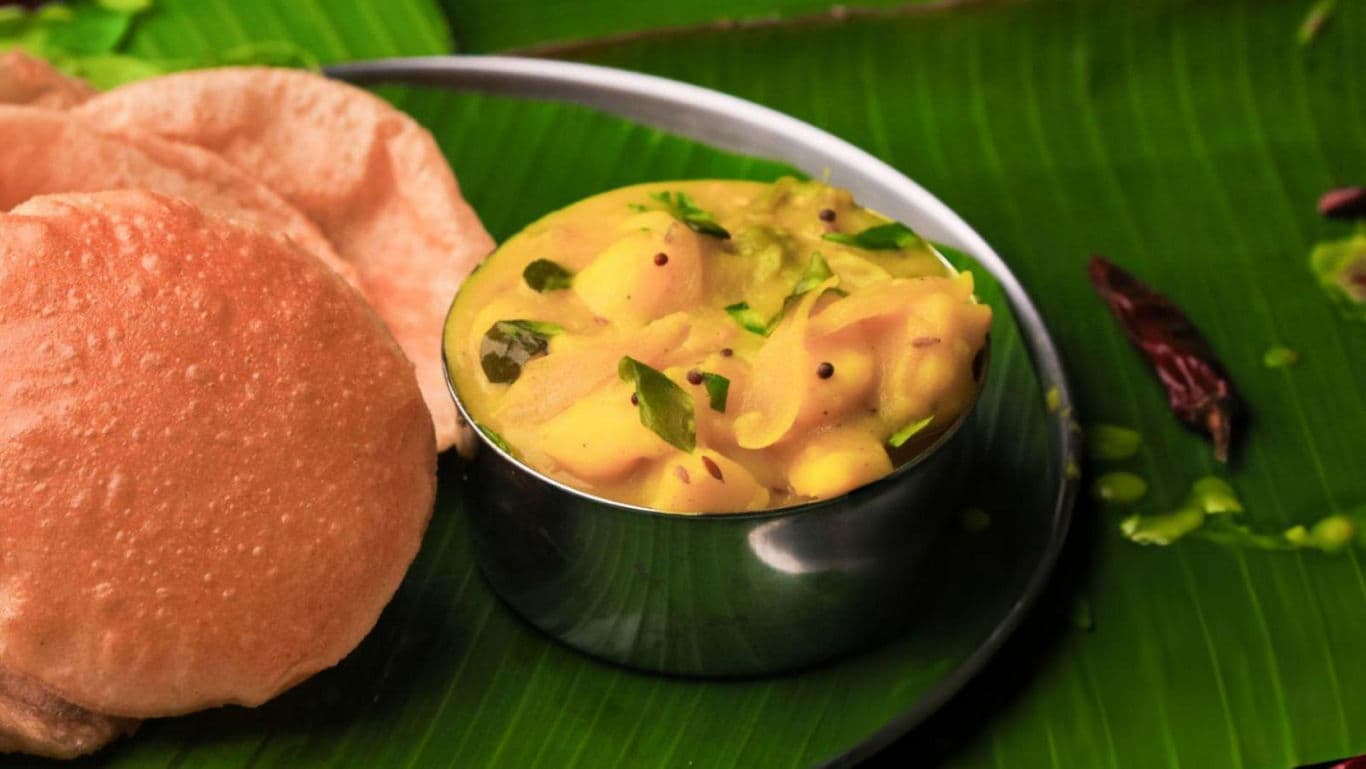 South Indian Poori with Potato Curry on Banana Leaf