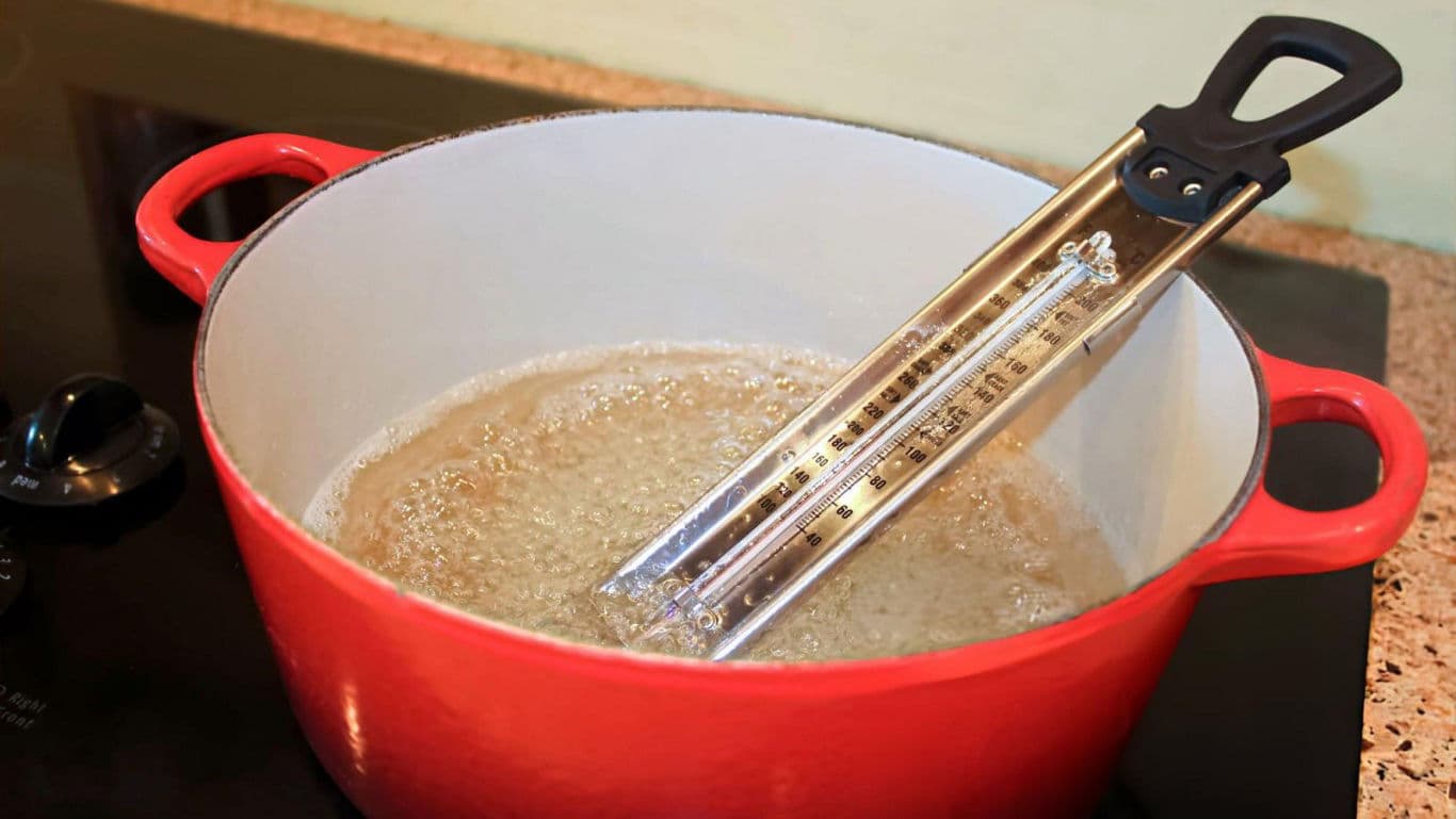Red pot with candy thermometer in use