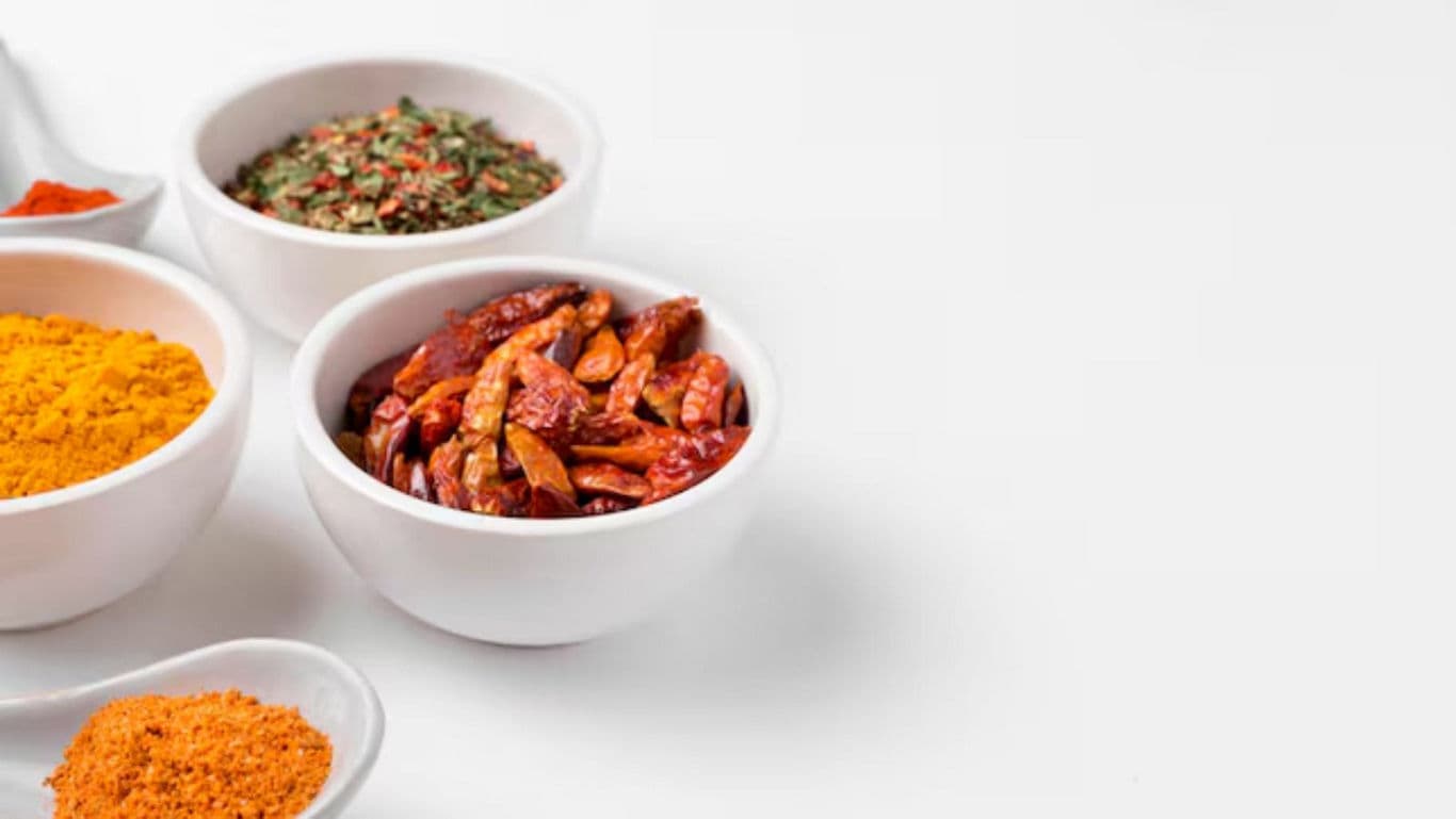 Assorted Spices and Dried Chilies in White Bowls