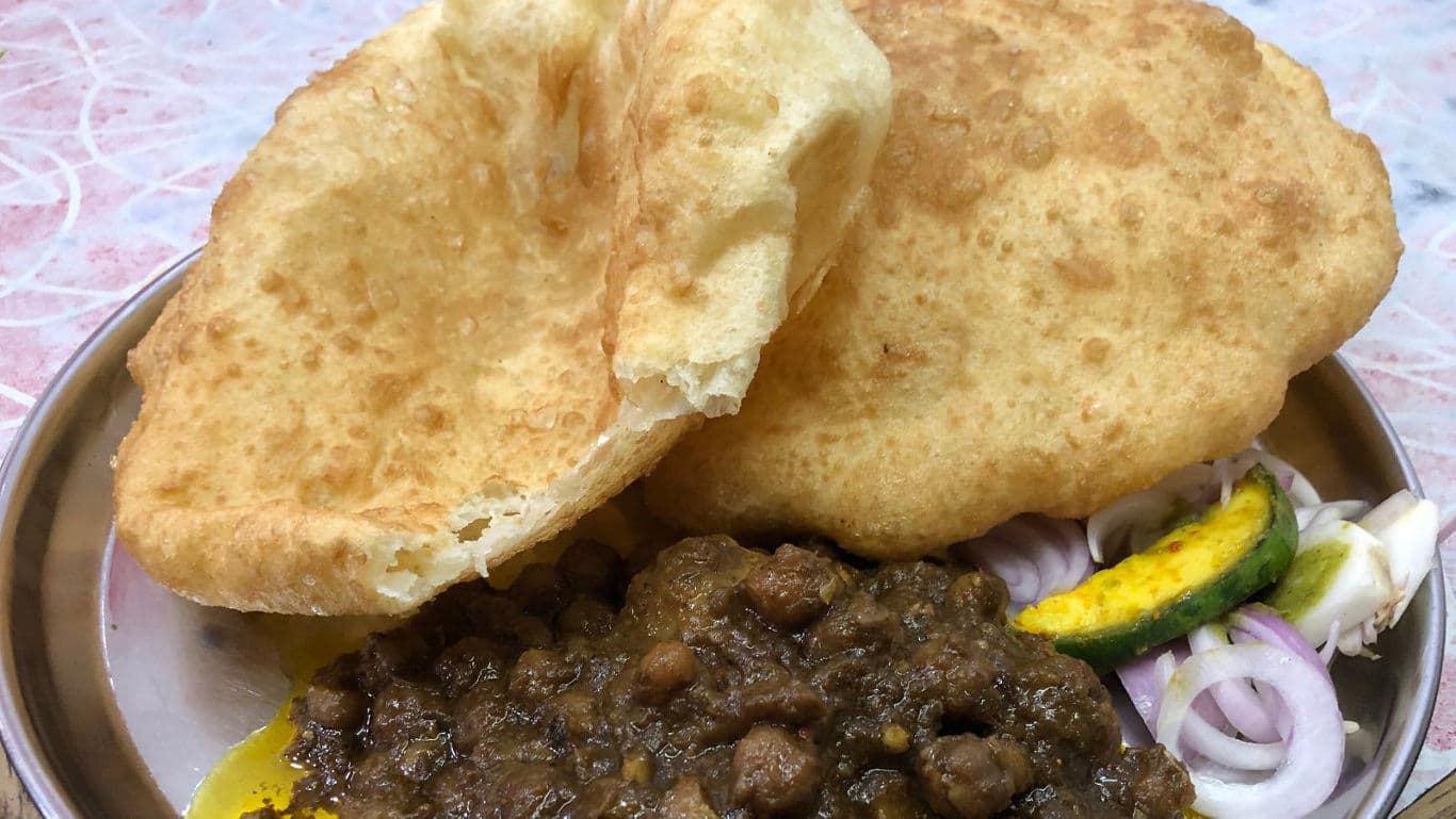Indian chole bhature with salad garnish