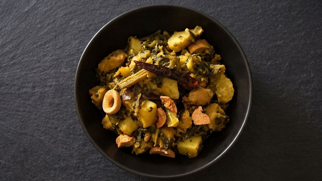 Spiced Potato and Greens Curry in Black Bowl