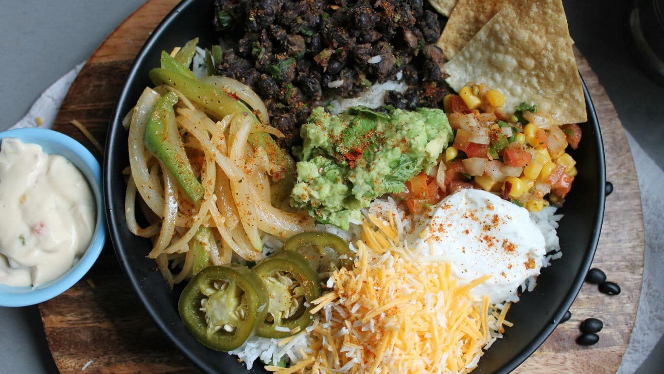 Colorful Mexican rice bowl with toppings