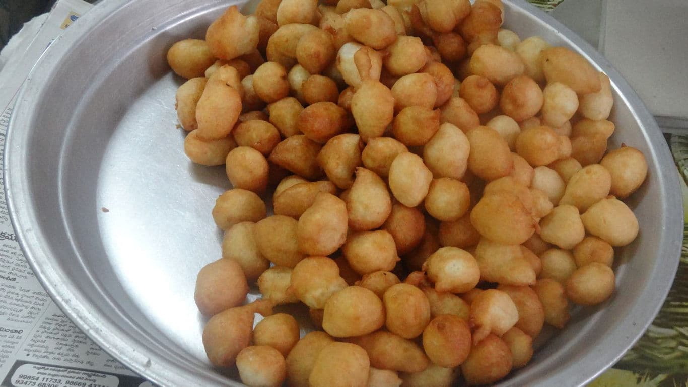 Round Golden Brown Fried Snack Balls in Tray