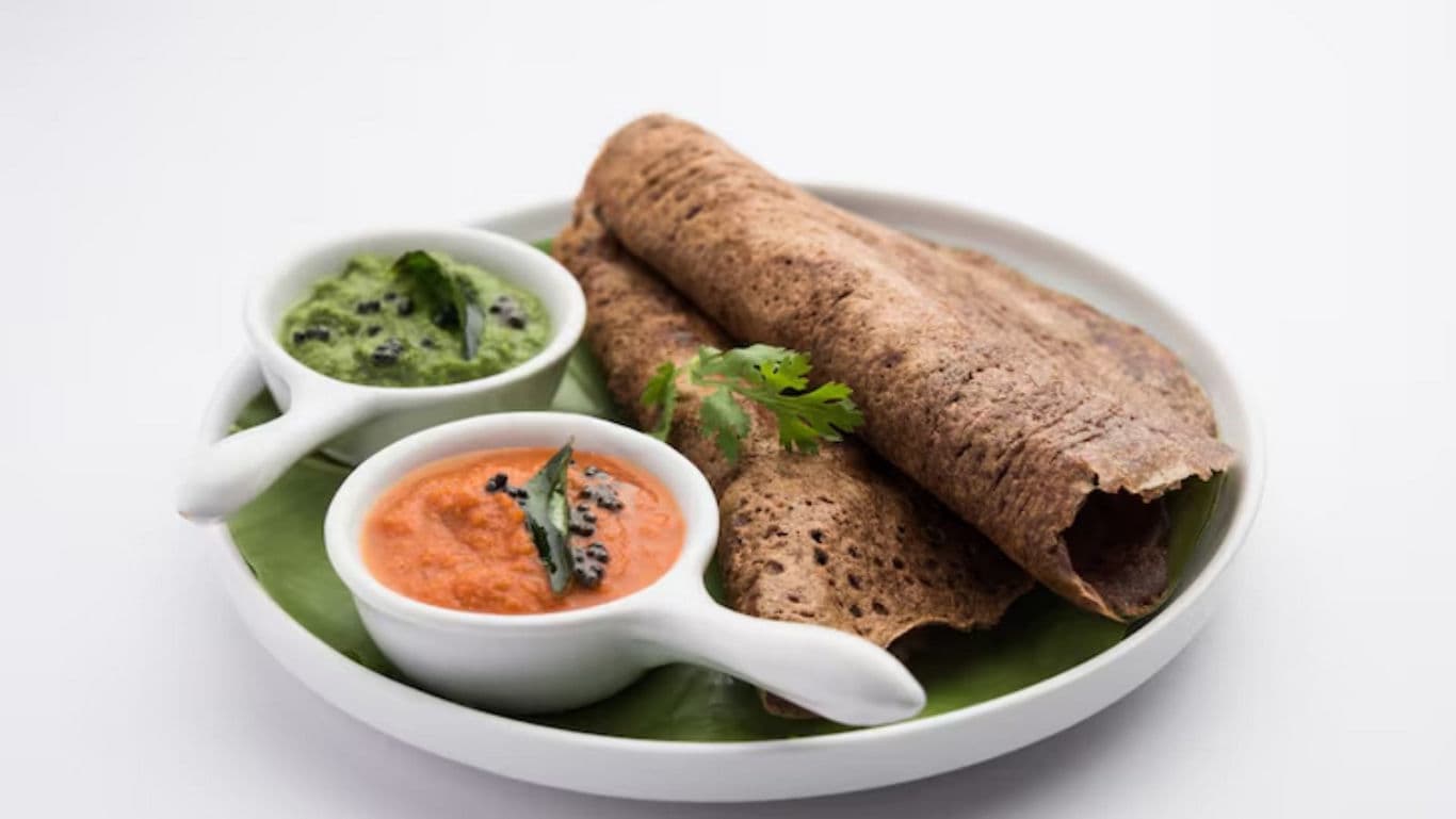 Ragi dosa with coconut and tomato chutney on plate