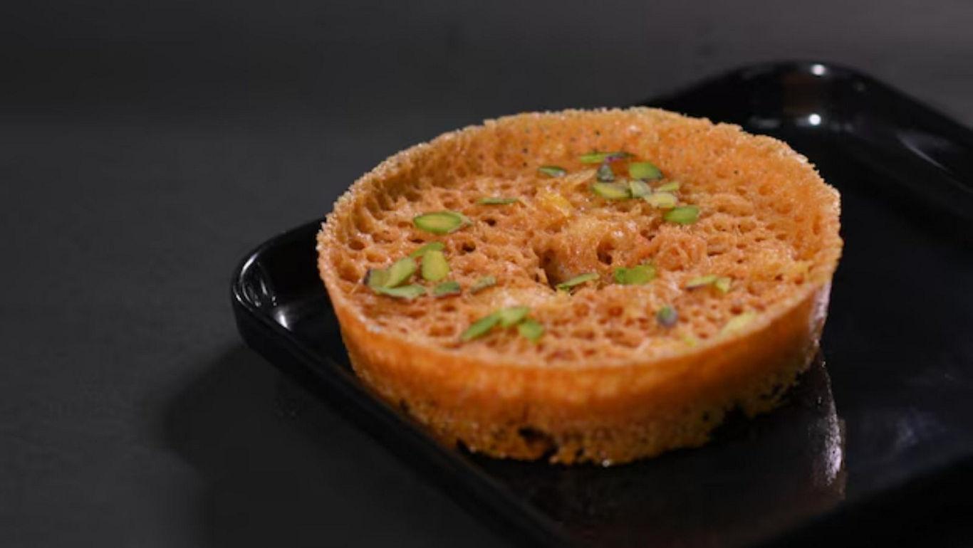 Golden honeycomb dessert with pistachio garnish