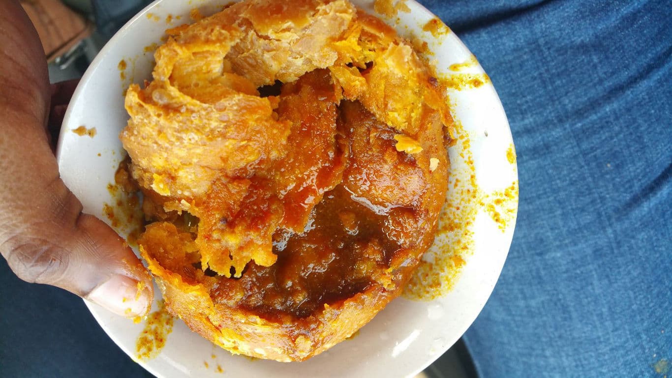 Hand Holding Bowl of African Street Food