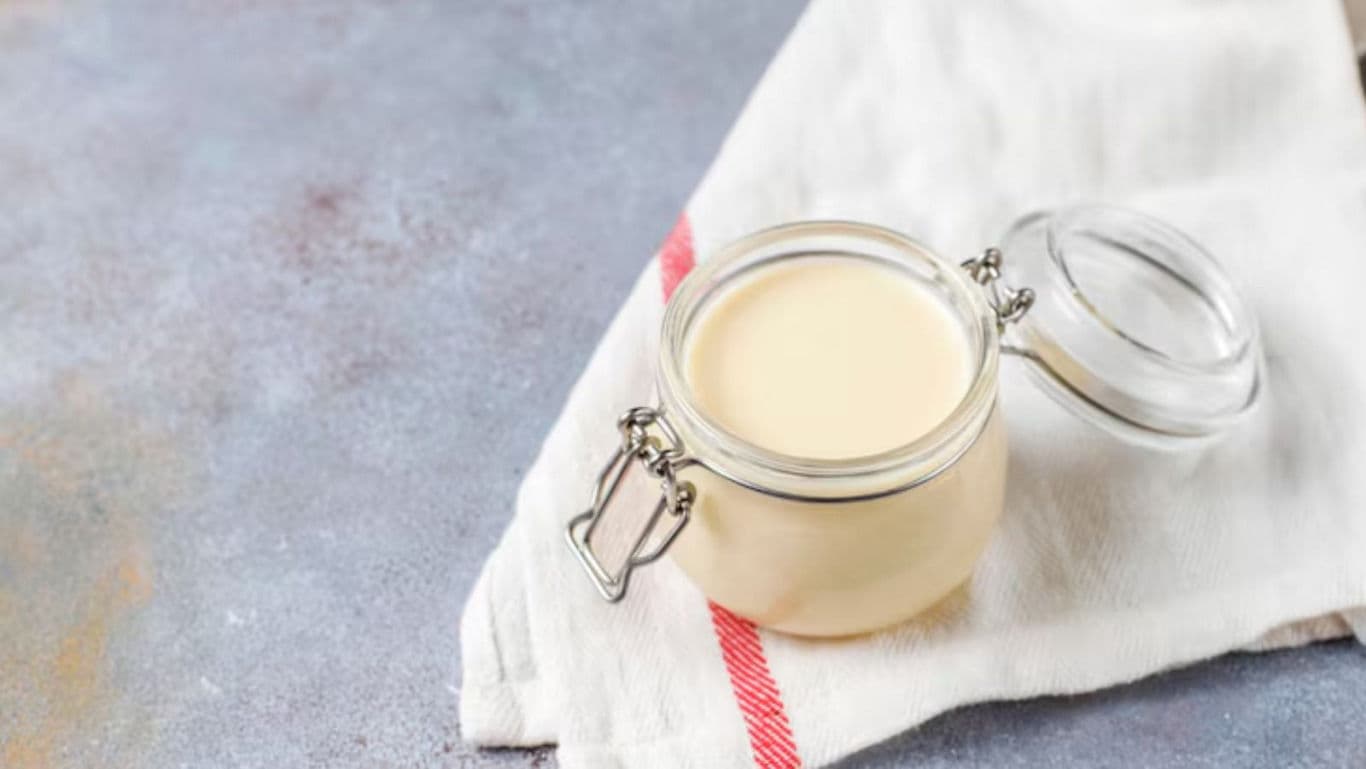 Glass jar of creamy condensed milk