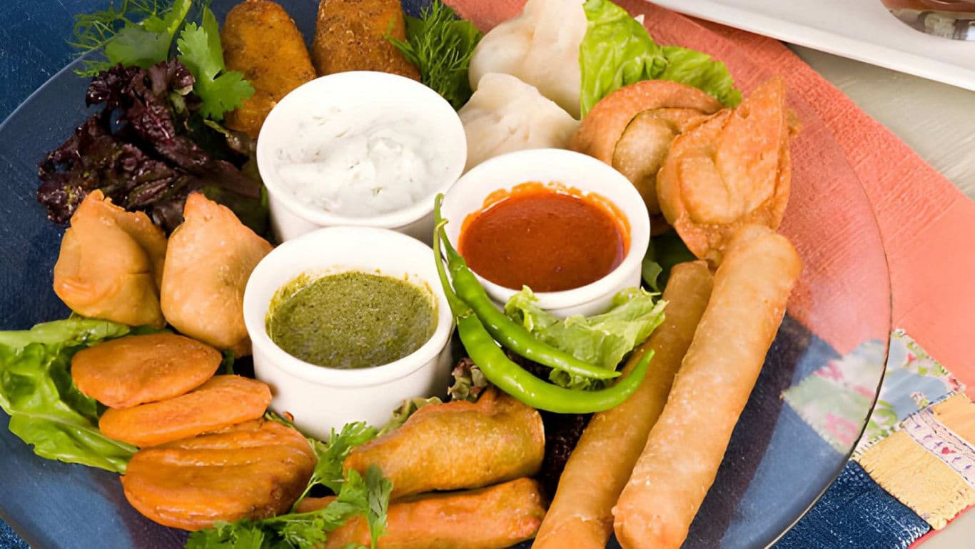Assorted fried snacks with dipping sauces