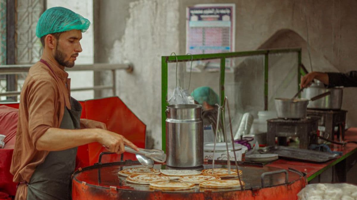 person cooking laccha parathas