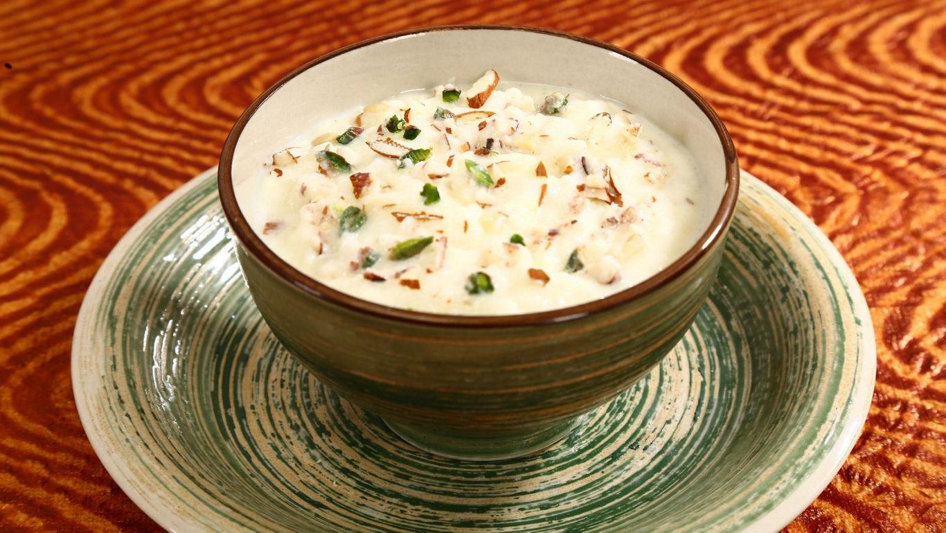 Creamy dessert bowl with nuts and garnish