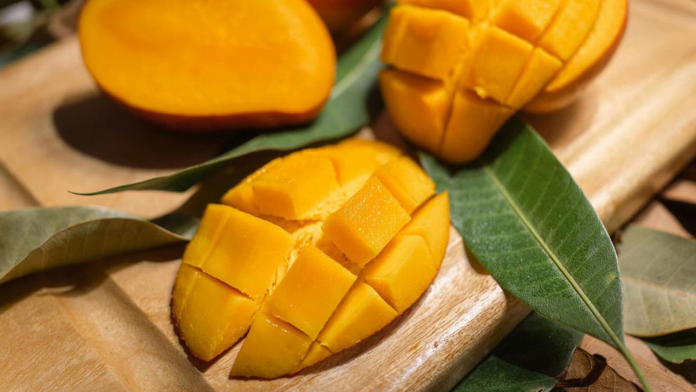Freshly Cut Ripe Mango on Wooden Board