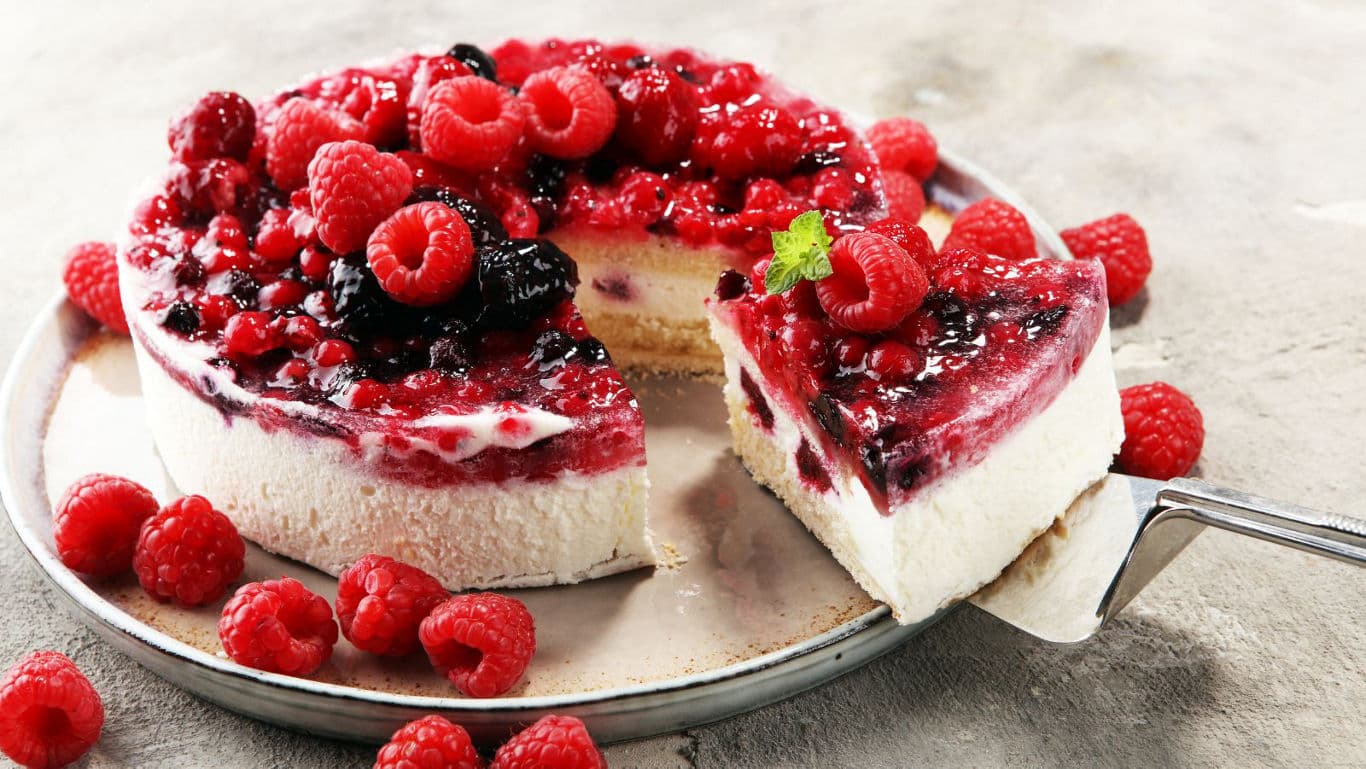 Mixed berry cheesecake with fresh raspberries on plate