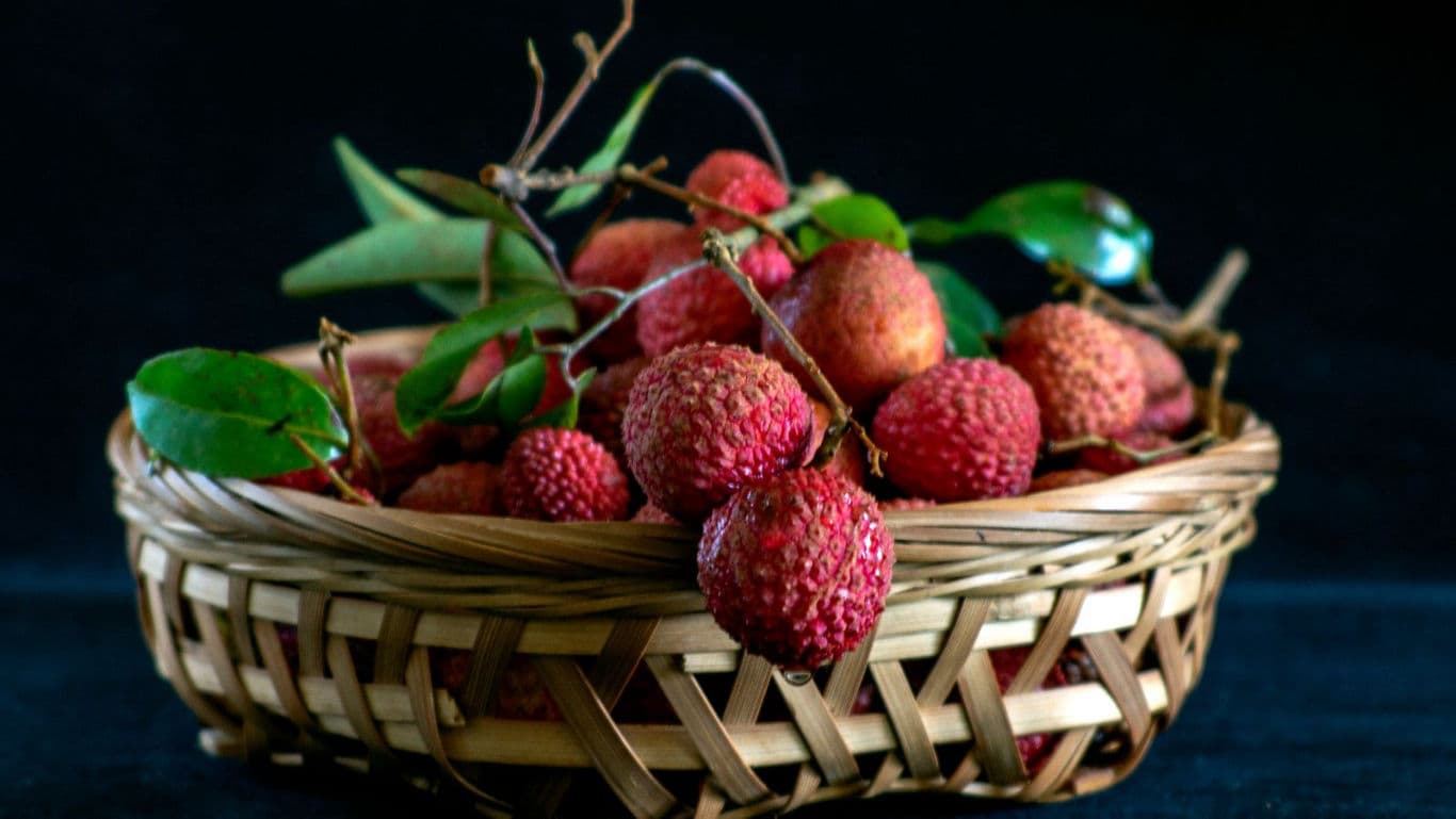 Fresh lychees in rustic woven basket
