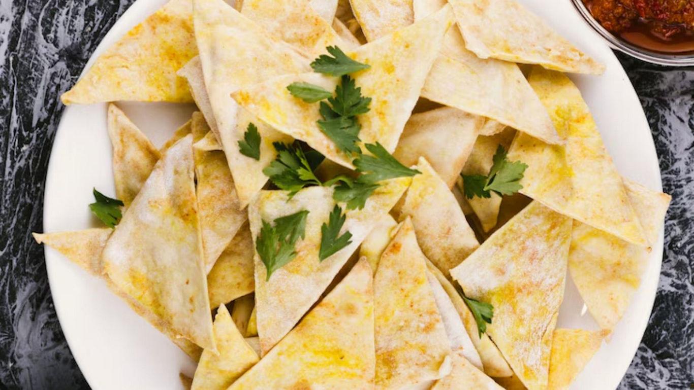 Crispy tortilla chips with parsley garnish