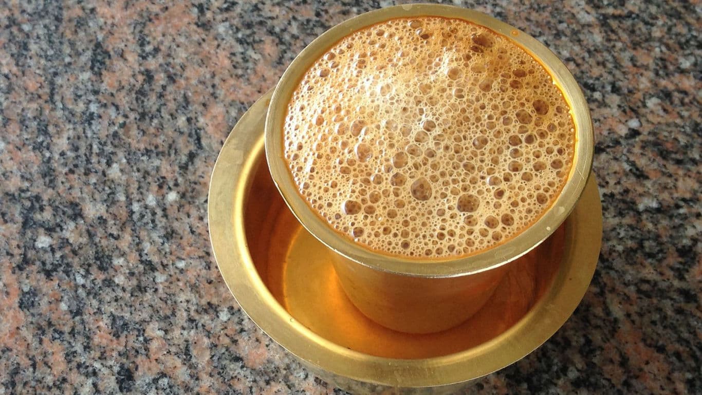 Traditional South Indian filter coffee in brass tumbler