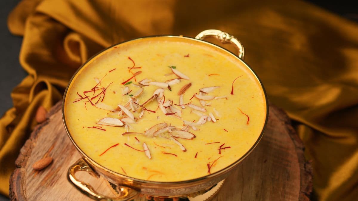 Amrakhand garnished with nuts and saffron.