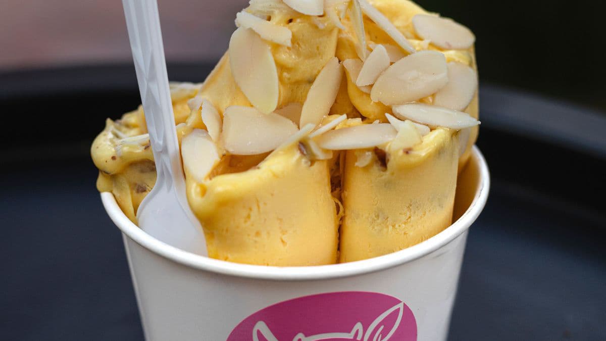 Mango kulfi garnished with nuts.