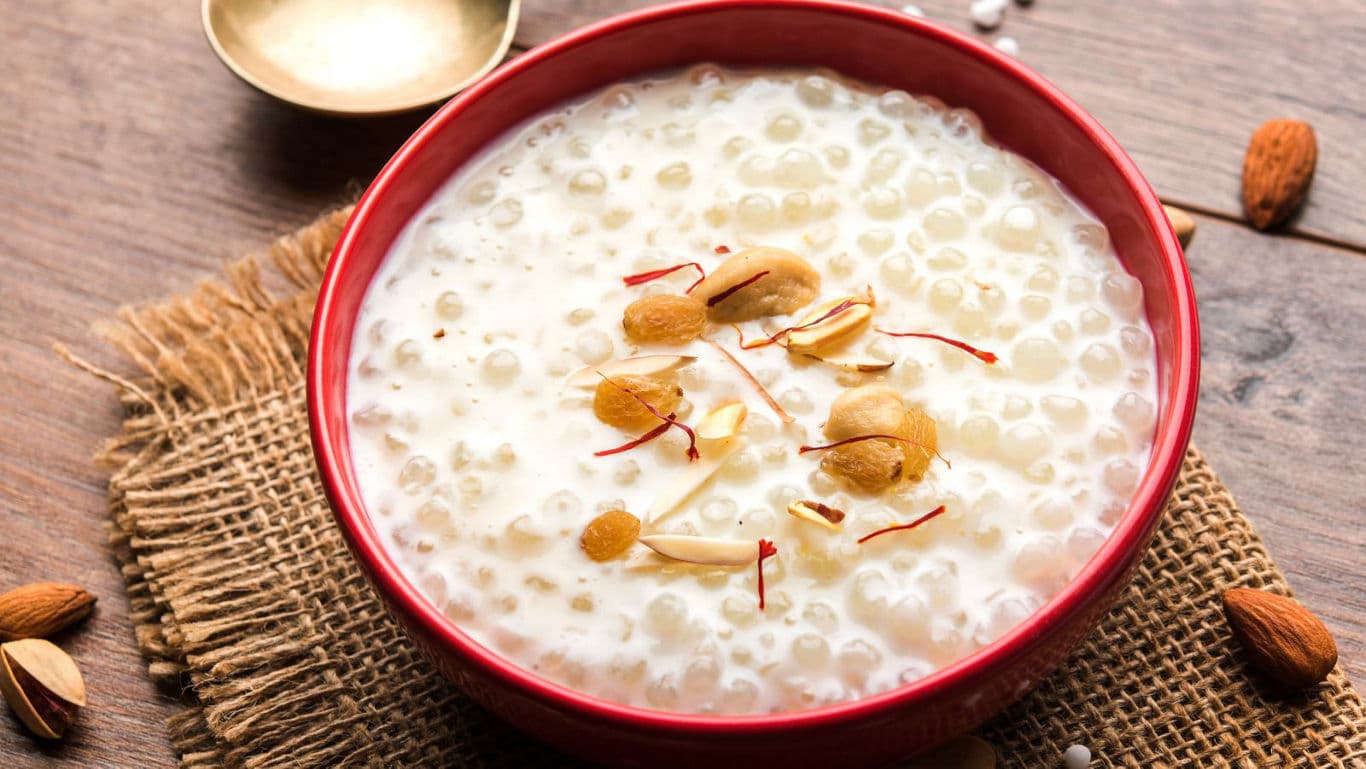 Creamy tapioca pudding with nuts in red bowl