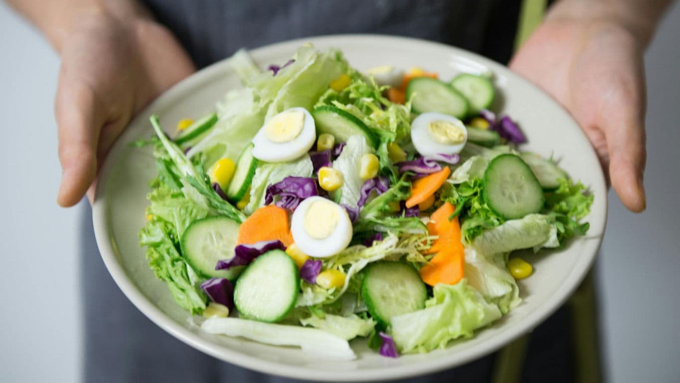 Fresh vegetable salad with boiled eggs served