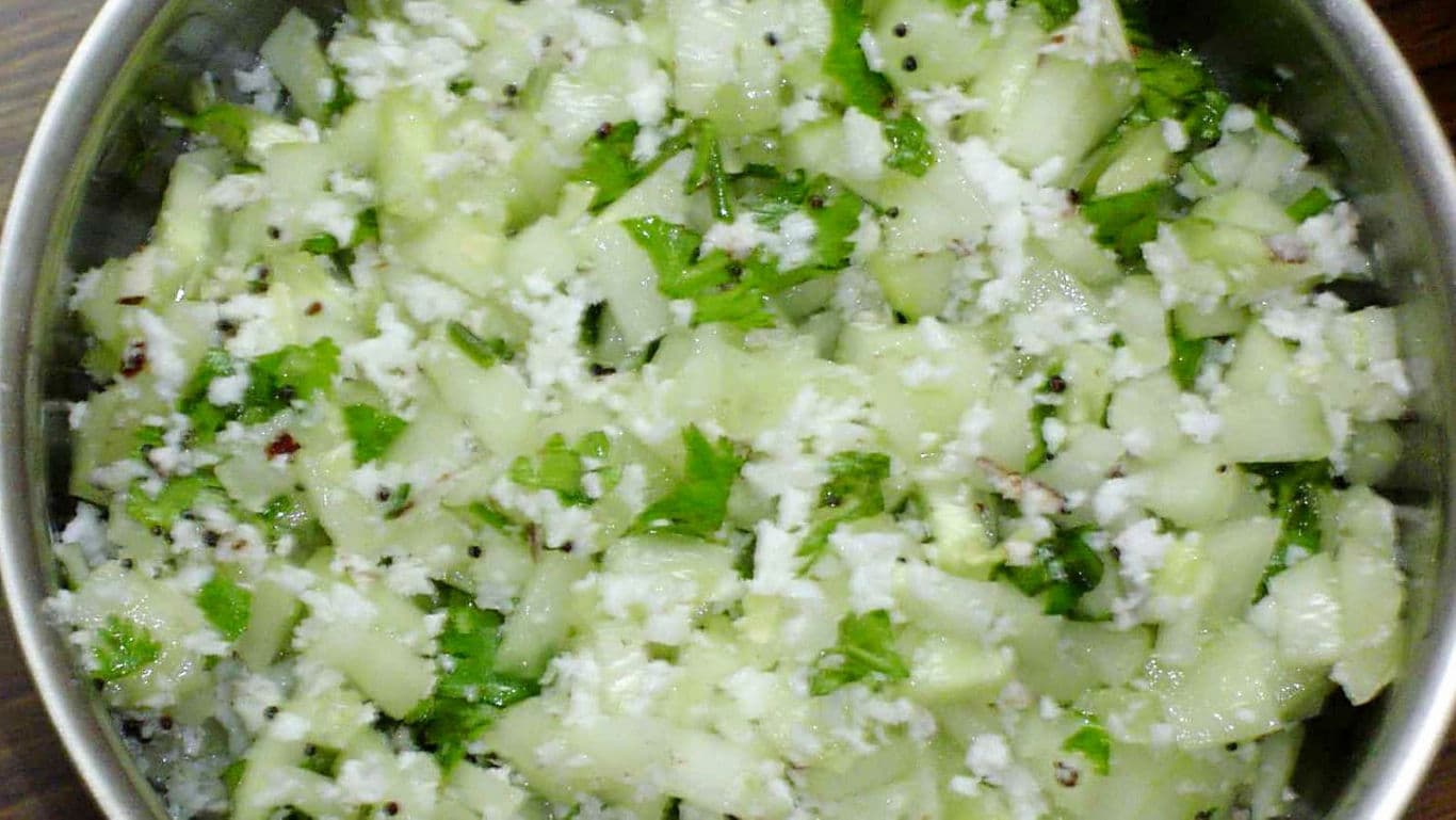 Cucumber coconut salad with fresh herbs in bowl
