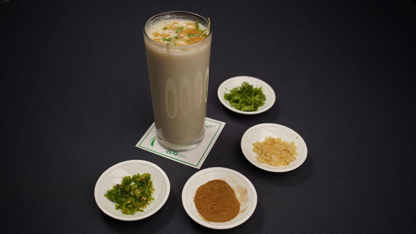 Tall savory beverage with assorted condiments