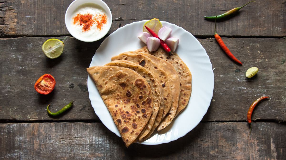 sattu khapli wheat paratha on a white plate