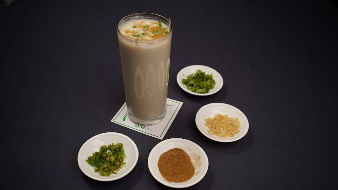 Tall glass of buttermilk with assorted condiments