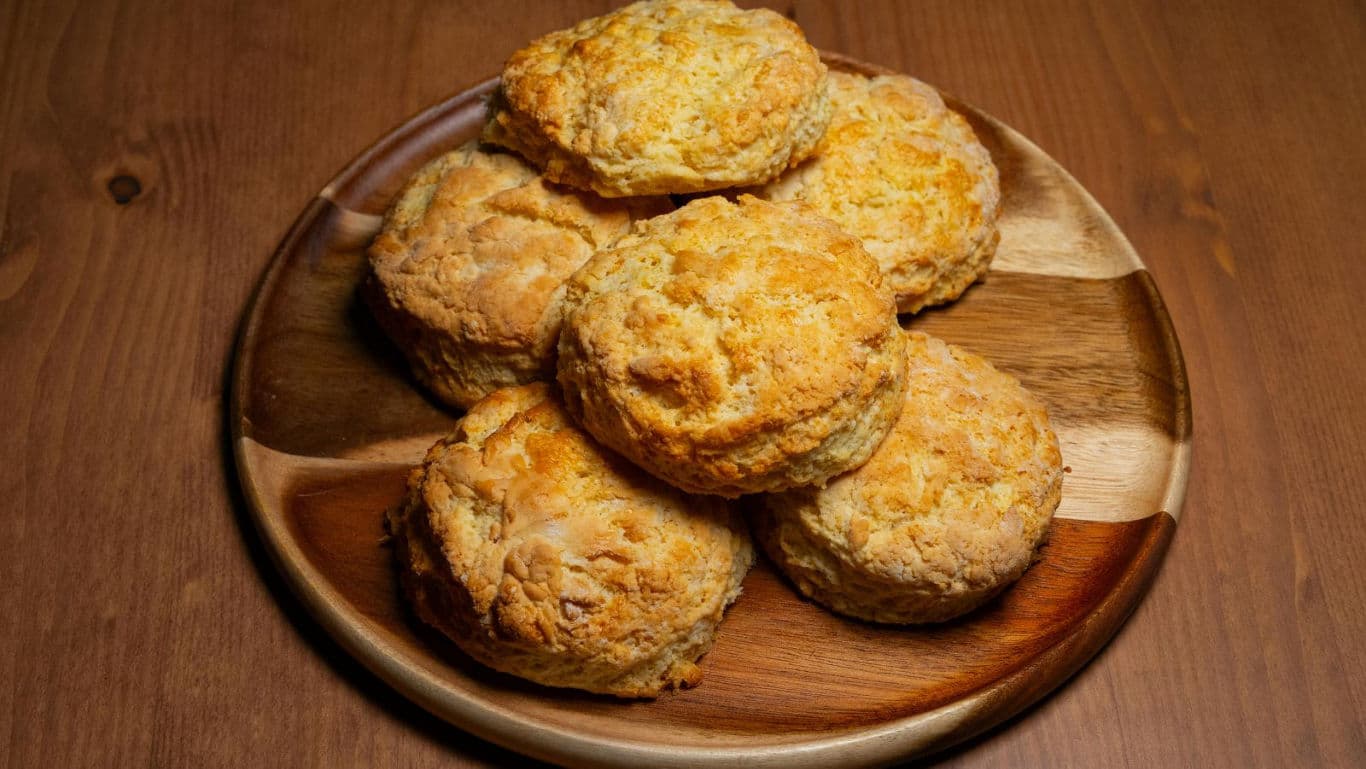 Freshly baked biscuits on wooden plate