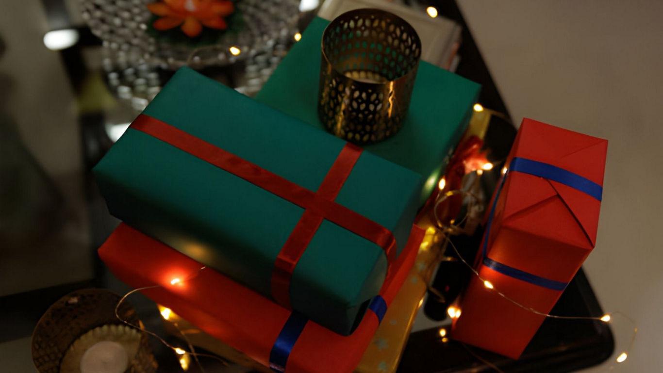 Festive wrapped gifts with glowing lights