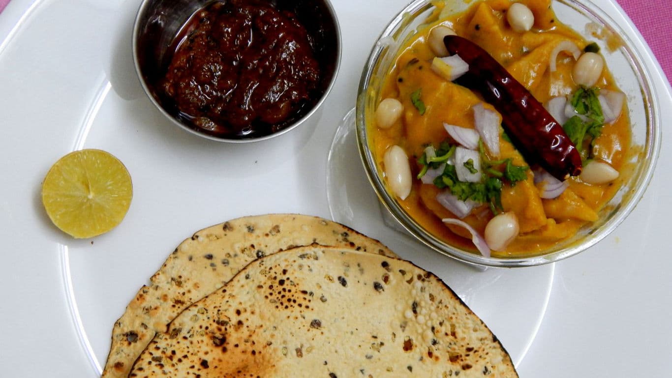 Indian meal with papad, curry and pickle