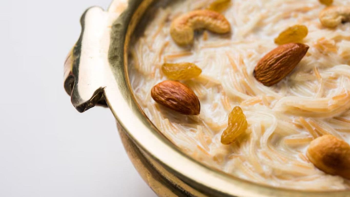 Traditional Indian kheer dessert with nuts in brass bowl