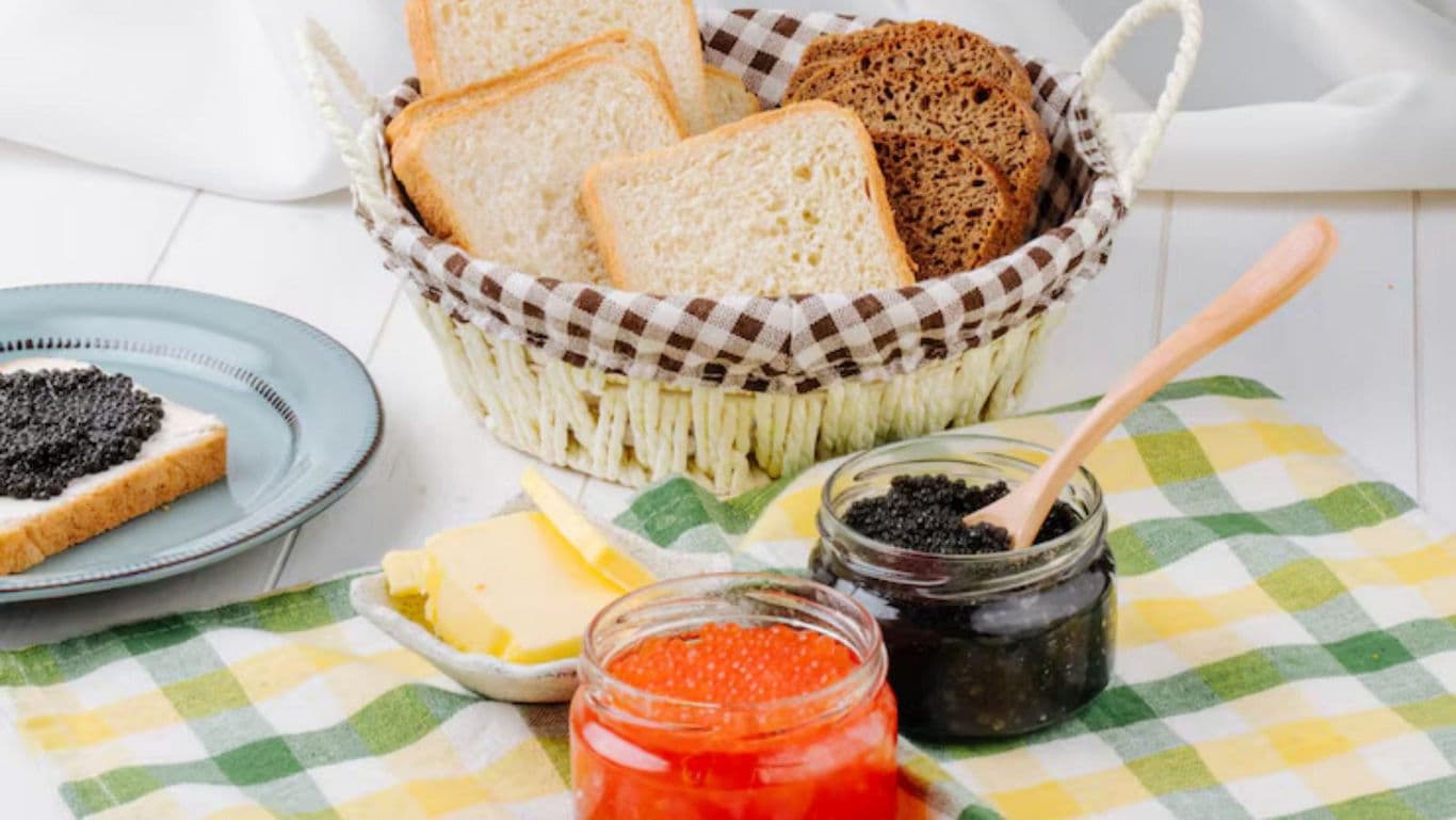 Assorted breads with red and black caviar jars