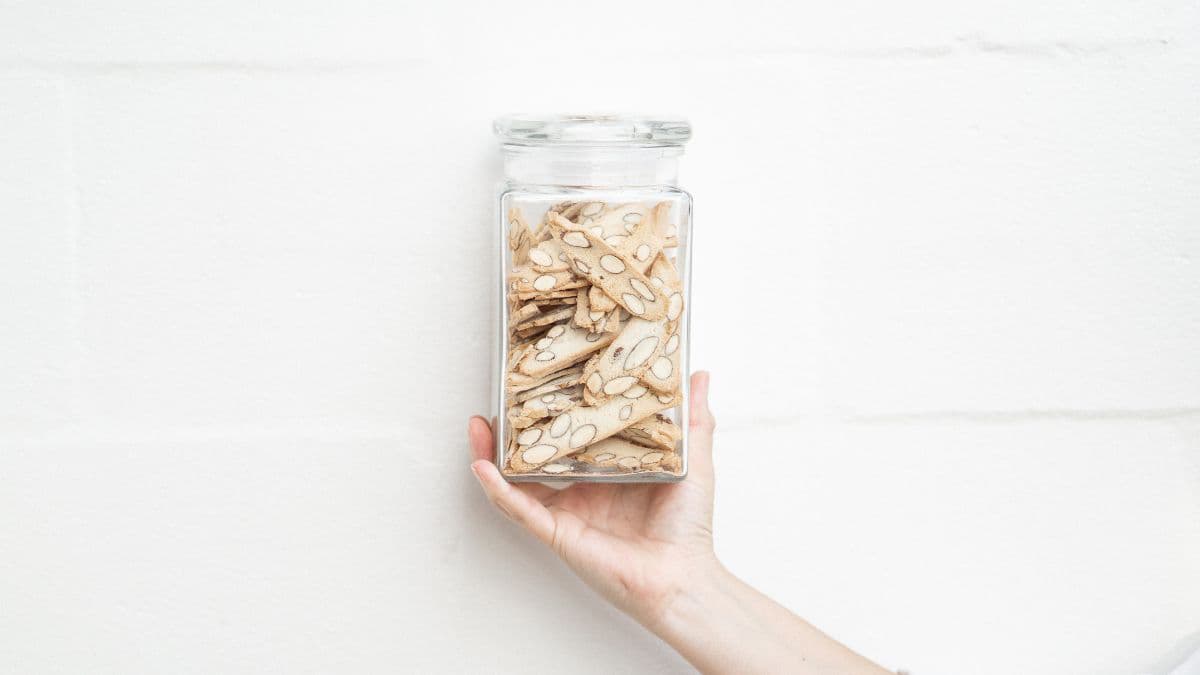 Man holding a jar of biscotti